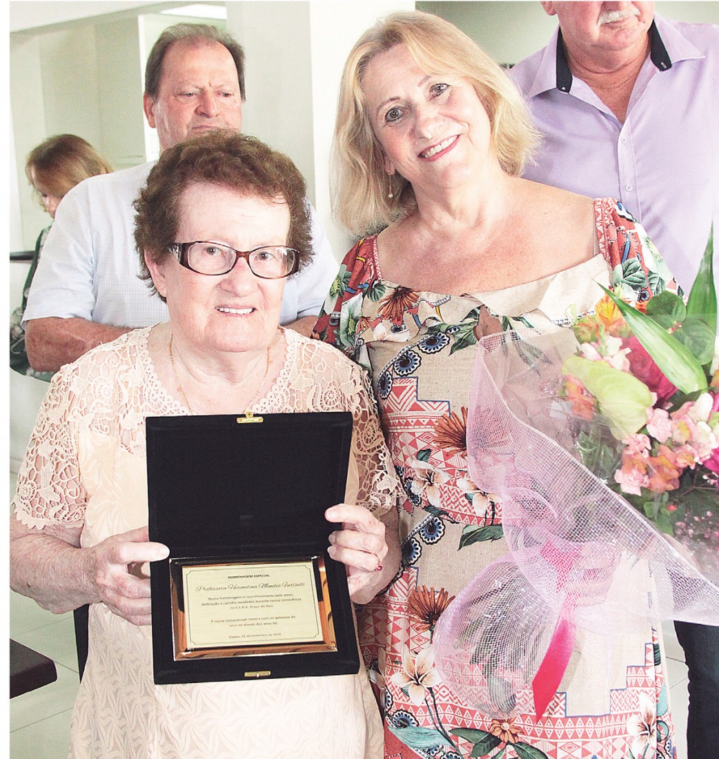 A professora Herondina (E) e a homenagem no primeiro encontro em 2019