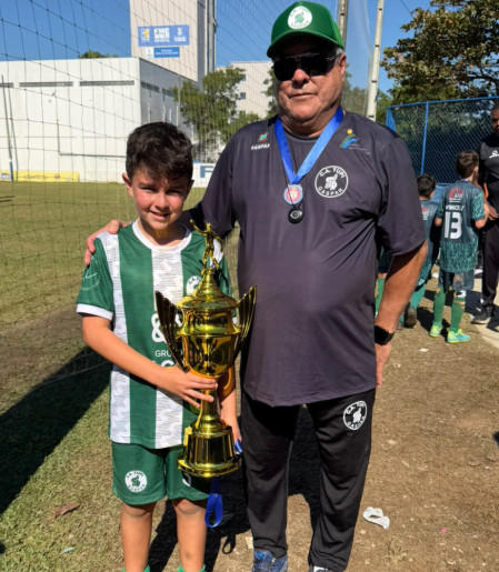 Atleta com o trof&eacute;u e o t&eacute;cnico Cel&ccedil;o Nicodemus